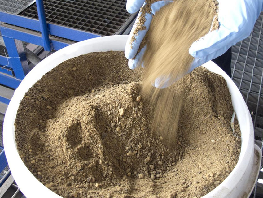 Soil poured into a large bucket