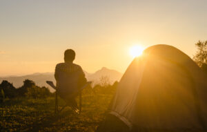 Man watching sunset while camping.